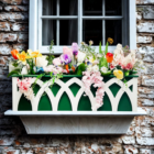 gothic lattice flower box / planter box on a window seal, painted green while leaving the arches white.