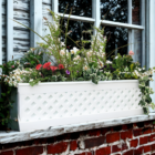 white pvc lattice style under the window planter box / flower box
