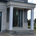 front porch of a home with two shark style pvc column post wraps at the entrance.